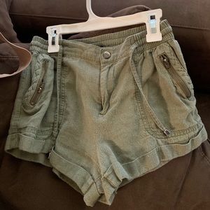 Military green shorts.